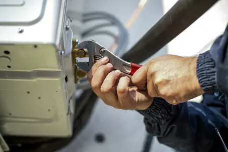 man fixing a generator